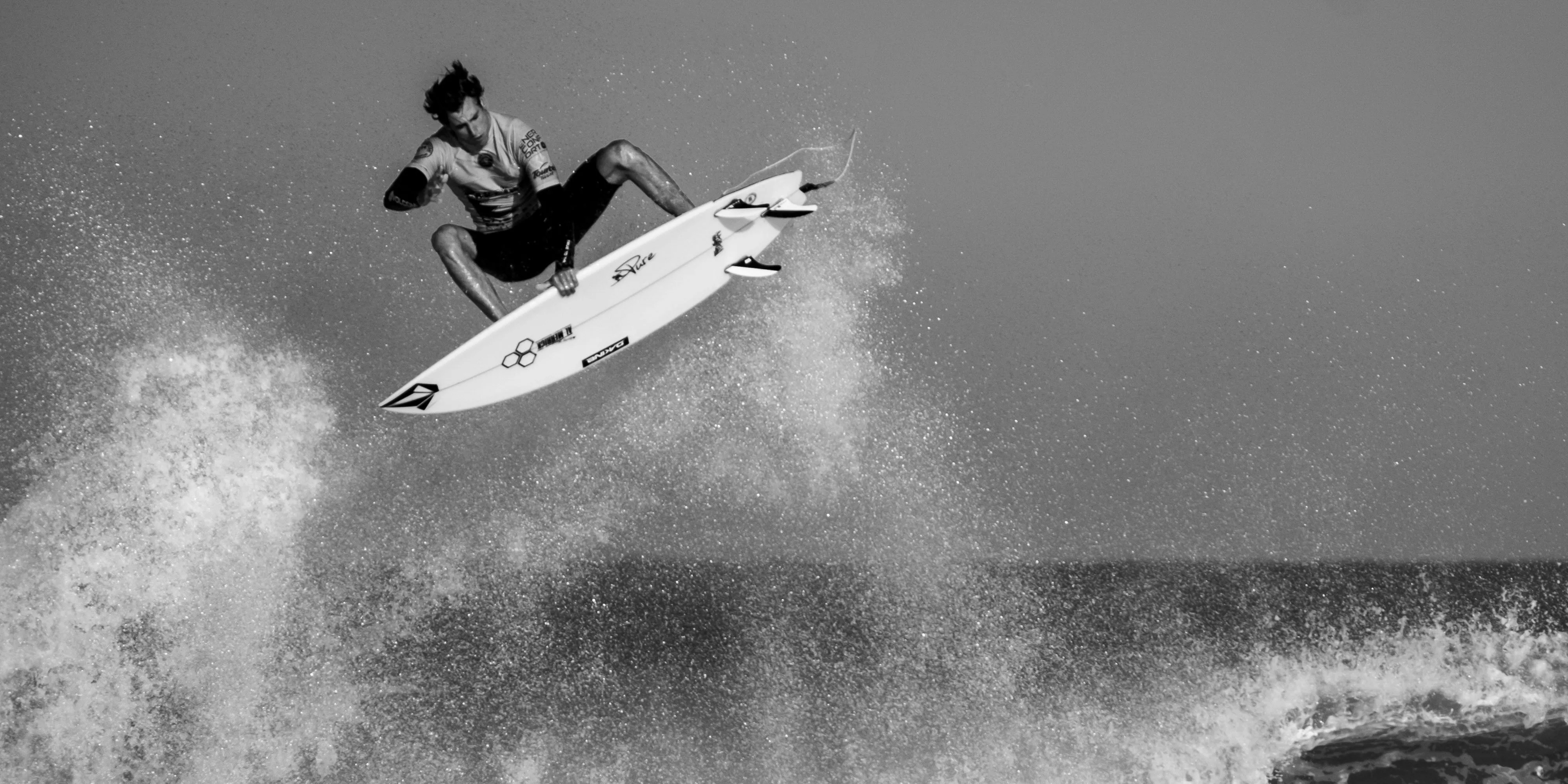 Black and white photograph of a surfer